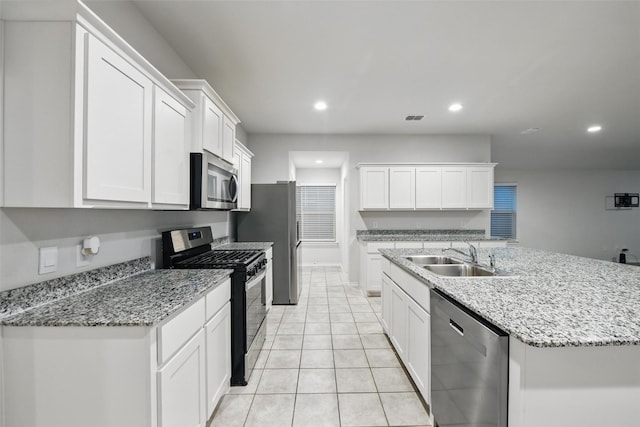 624 Whitecomb Ln, Justin, TX 76247 - kitchen with visible vents, recessed lighting, white cabinetry, a sink, and stainless steel appliances
