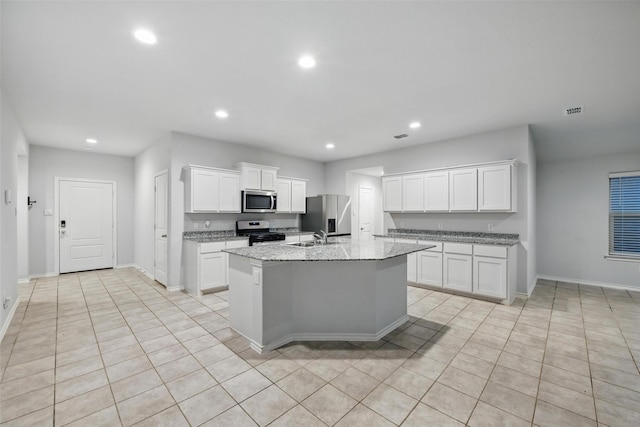 624 Whitecomb Ln, Justin, TX 76247 - kitchen with a kitchen island with sink, baseboards, recessed lighting, white cabinets, and stainless steel appliances