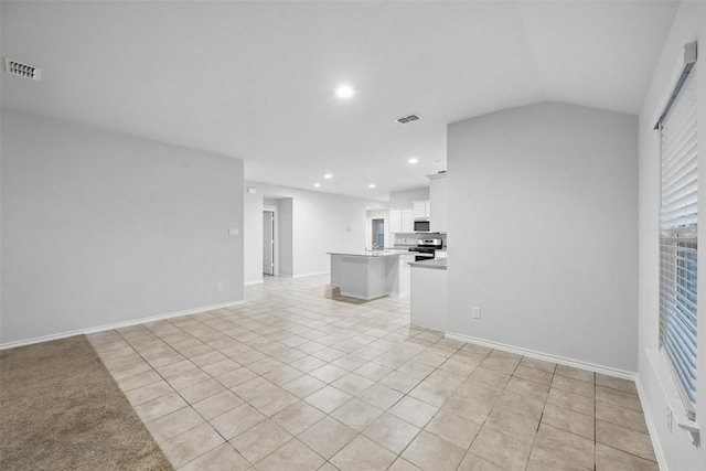 624 Whitecomb Ln, Justin, TX 76247 - unfurnished living room with light tile patterned floors, lofted ceiling, recessed lighting, and visible vents