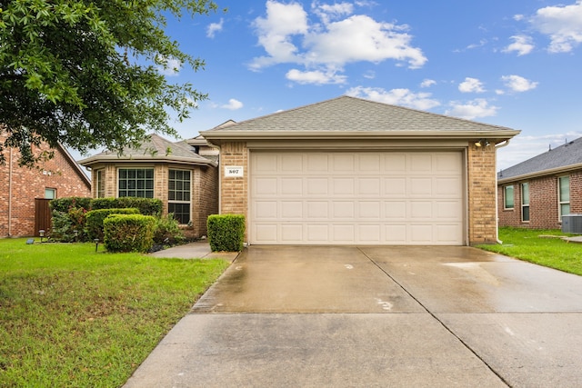 ranch-style house with an attached garage, driveway, a front lawn, and brick siding