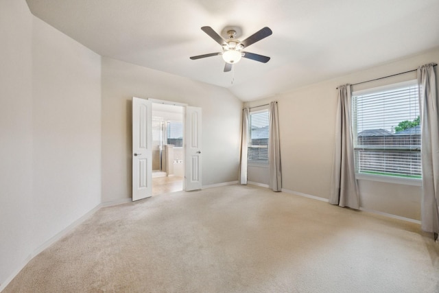 unfurnished room with a ceiling fan, baseboards, and light colored carpet