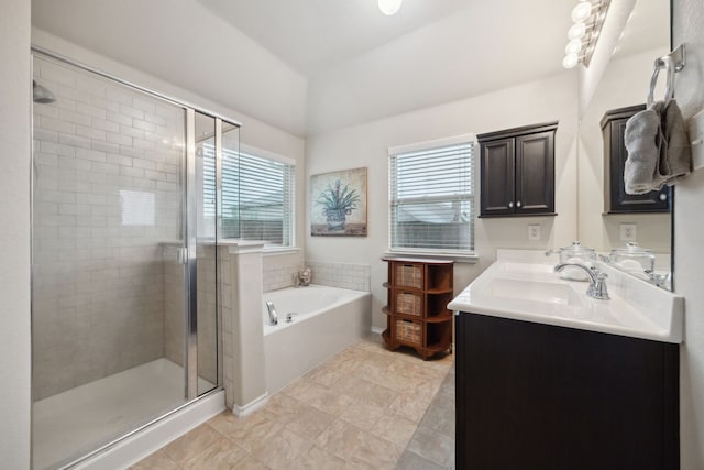 full bathroom featuring vanity, a stall shower, lofted ceiling, and a bath