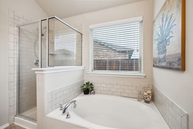 full bath featuring a garden tub and a shower stall