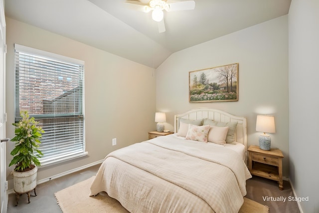 carpeted bedroom with baseboards, a ceiling fan, and lofted ceiling