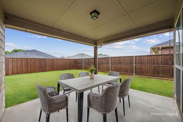 view of patio with a fenced backyard and outdoor dining space