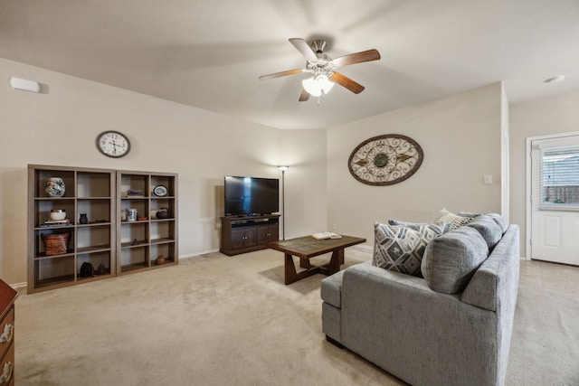 living area featuring ceiling fan, light colored carpet, and baseboards