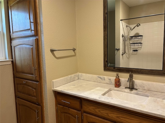 bathroom featuring vanity and a textured wall