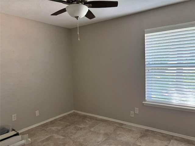 empty room with baseboards and a ceiling fan