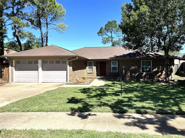 single story home featuring brick siding, driveway, a front lawn, and a garage