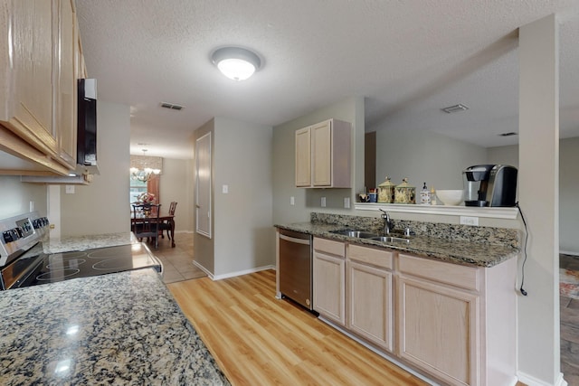 3073 Dusty Ridge Dr, Rockwall, TX 75032 - kitchen featuring a sink, appliances with stainless steel finishes, light brown cabinetry, and visible vents