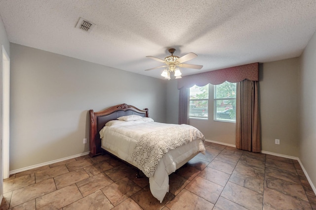 3073 Dusty Ridge Dr, Rockwall, TX 75032 - bedroom featuring a textured ceiling, ceiling fan, visible vents, and baseboards