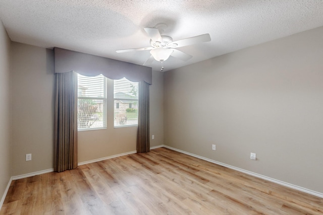 3073 Dusty Ridge Dr, Rockwall, TX 75032 - unfurnished room with a ceiling fan, a textured ceiling, baseboards, and light wood-type flooring