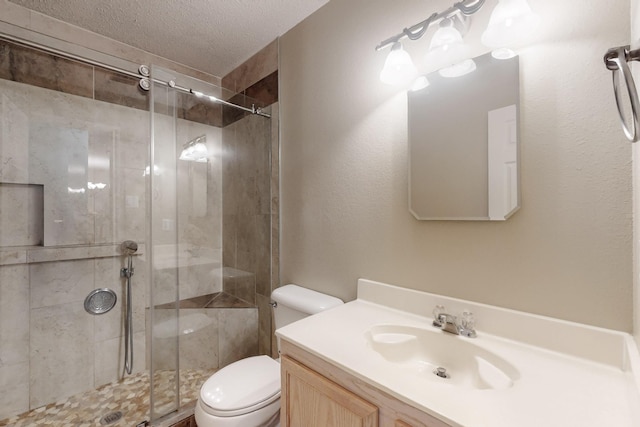 3073 Dusty Ridge Dr, Rockwall, TX 75032 - full bath with vanity, a textured ceiling, a stall shower, and toilet