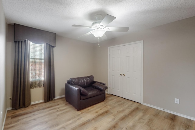 3073 Dusty Ridge Dr, Rockwall, TX 75032 - sitting room featuring light wood-style floors, baseboards, ceiling fan, and a textured ceiling