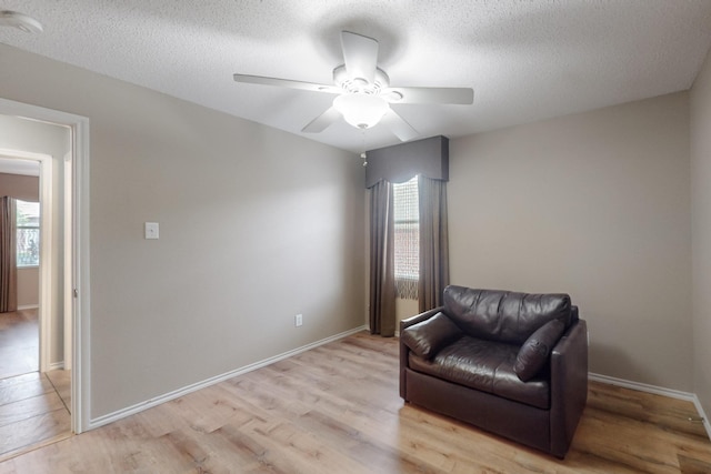 3073 Dusty Ridge Dr, Rockwall, TX 75032 - sitting room featuring a healthy amount of sunlight, a ceiling fan, light wood-type flooring, and a textured ceiling