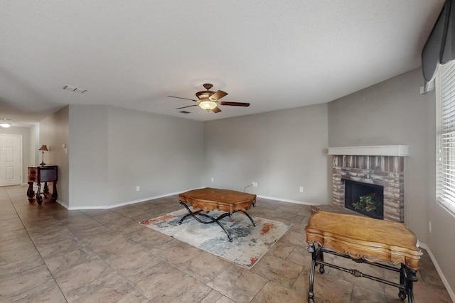 3073 Dusty Ridge Dr, Rockwall, TX 75032 - unfurnished living room featuring visible vents, plenty of natural light, ceiling fan, and a fireplace