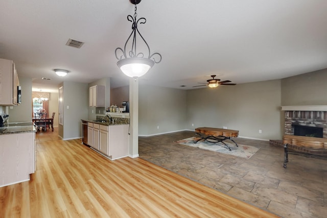 3073 Dusty Ridge Dr, Rockwall, TX 75032 - kitchen with a sink, a brick fireplace, baseboards, open floor plan, and visible vents