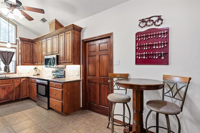 200 Bushwhacker Dr, Mabank, TX 75156 - kitchen with stainless steel appliances, a ceiling fan, light tile patterned floors, tasteful backsplash, and visible vents