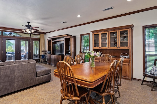 200 Bushwhacker Dr, Mabank, TX 75156 - dining space with crown molding, a ceiling fan, visible vents, and light tile patterned flooring