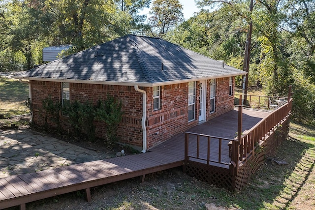 200 Bushwhacker Dr, Mabank, TX 75156 - exterior space featuring roof with shingles, a chimney, a deck, and brick siding