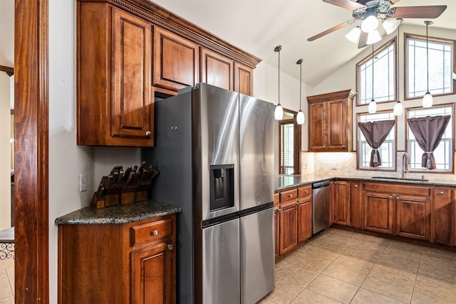 200 Bushwhacker Dr, Mabank, TX 75156 - kitchen with brown cabinetry, a ceiling fan, a sink, appliances with stainless steel finishes, and light tile patterned floors