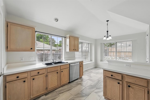 kitchen featuring decorative light fixtures, stainless steel dishwasher, a sink, light countertops, and a notable chandelier
