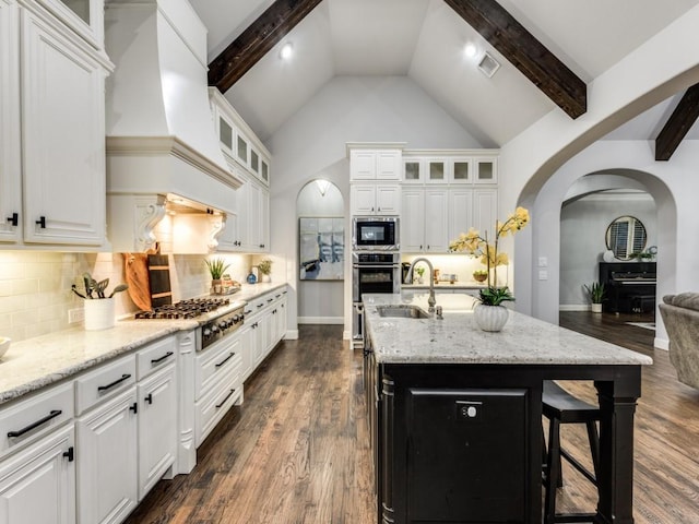 3515 Terrace Way, Celina, TX 75009 - kitchen featuring built in microwave, a sink, arched walkways, stainless steel gas cooktop, and high vaulted ceiling