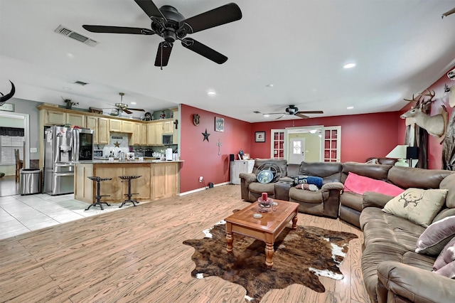 living room featuring visible vents, a ceiling fan, baseboards, and recessed lighting