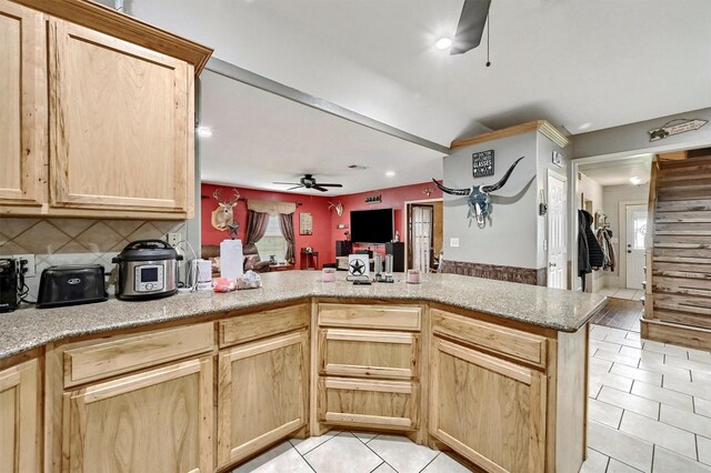 kitchen with decorative backsplash, a peninsula, light brown cabinetry, ceiling fan, and light tile patterned floors