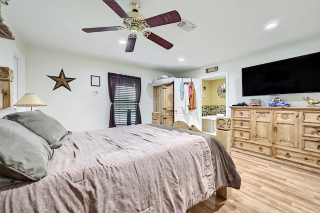 bedroom featuring ceiling fan, recessed lighting, ensuite bathroom, light wood-type flooring, and visible vents