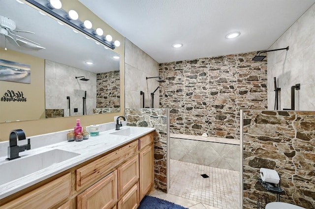 bathroom with a sink, a walk in shower, and recessed lighting