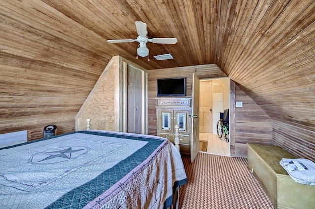 bedroom featuring visible vents, wood walls, wood ceiling, a ceiling fan, and vaulted ceiling