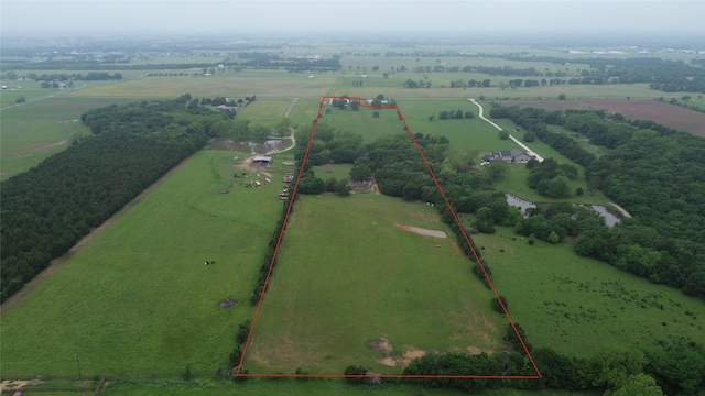 birds eye view of property with a rural view