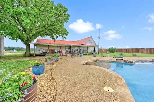 view of pool featuring a fenced in pool, fence, a yard, and a patio area