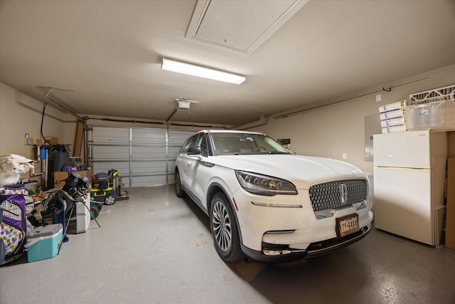 1408 Joshua Way, Granbury, TX 76048 - garage with freestanding refrigerator and a garage door opener