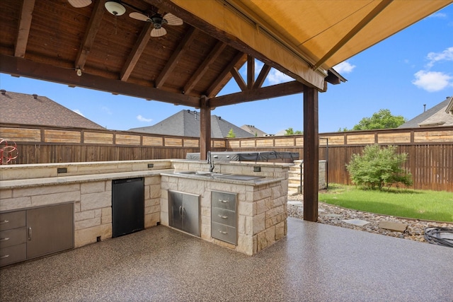 1408 Joshua Way, Granbury, TX 76048 - view of patio / terrace featuring a sink, an outdoor kitchen, ceiling fan, and a fenced backyard