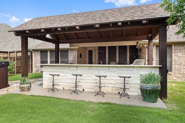 1408 Joshua Way, Granbury, TX 76048 - exterior space featuring brick siding, fence, outdoor dry bar, and roof with shingles