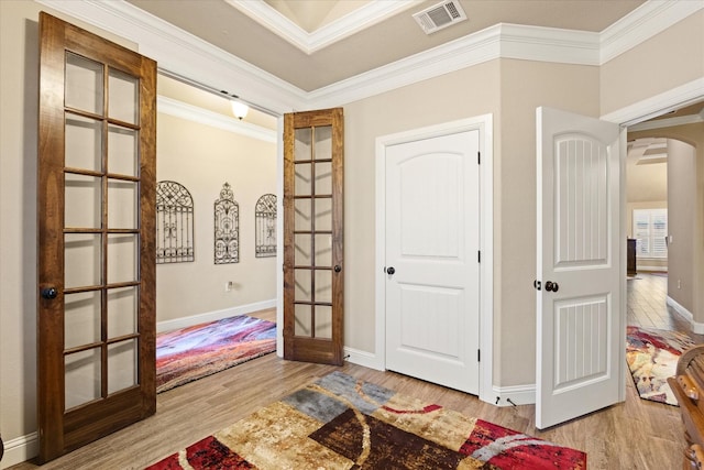 1408 Joshua Way, Granbury, TX 76048 - foyer entrance with crown molding, arched walkways, french doors, wood finished floors, and visible vents