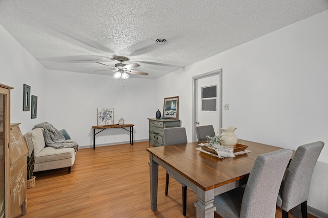 356 Bedford Ct E, Bedford, TX 76022 - dining space featuring a textured ceiling, ceiling fan, light wood-style flooring, and visible vents