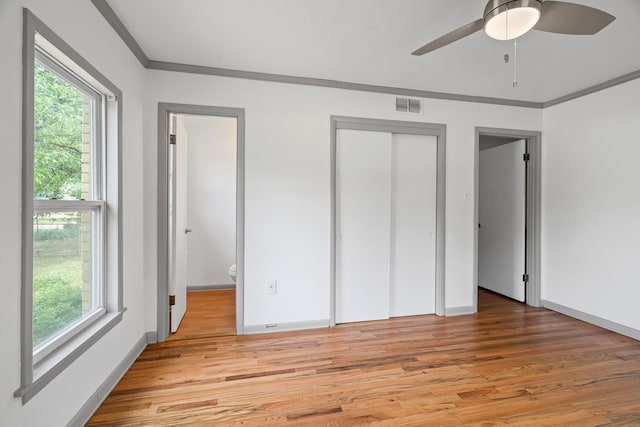 356 Bedford Ct E, Bedford, TX 76022 - unfurnished bedroom with baseboards, ornamental molding, light wood-type flooring, and visible vents