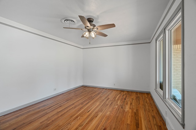 356 Bedford Ct E, Bedford, TX 76022 - unfurnished room with visible vents, baseboards, ceiling fan, and wood finished floors