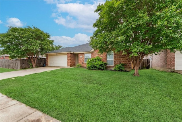 view of front facade featuring a front yard, a garage, brick siding, fence, and concrete driveway