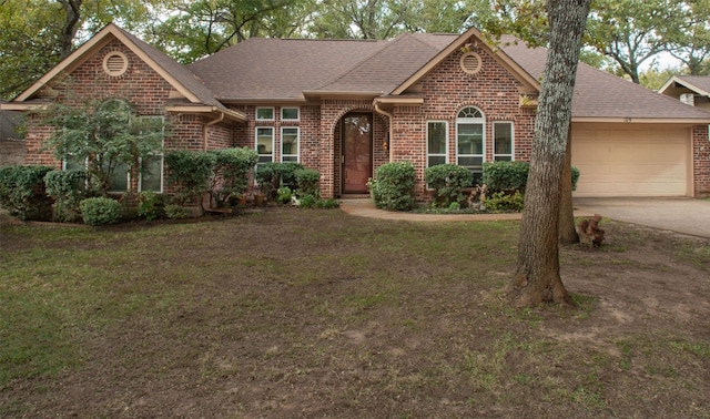ranch-style house featuring a shingled roof, an attached garage, driveway, and brick siding