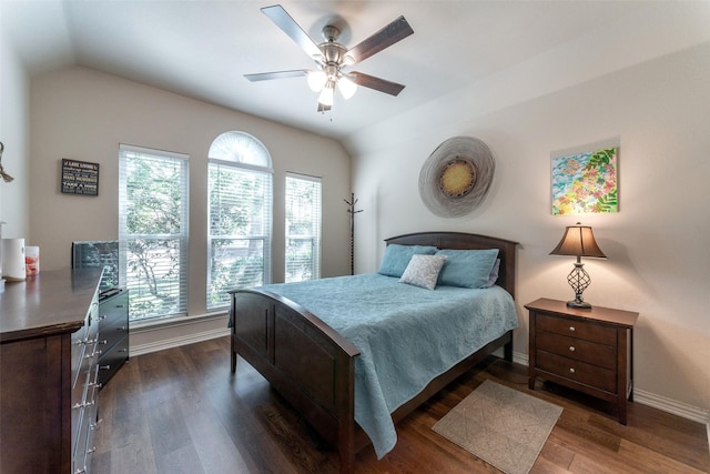 bedroom featuring baseboards, ceiling fan, vaulted ceiling, and dark wood-type flooring