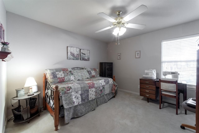 carpeted bedroom with baseboards and a ceiling fan