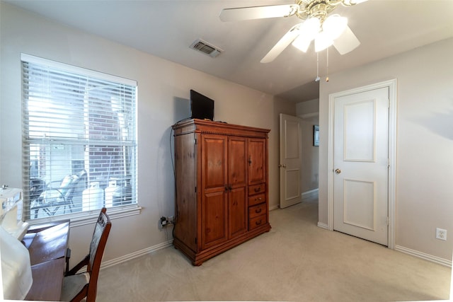 office area with visible vents, baseboards, ceiling fan, and light colored carpet