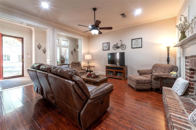 living room featuring visible vents, a ceiling fan, dark wood-style flooring, and plenty of natural light