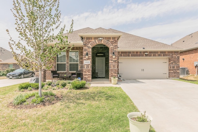 2825 Jasper Trl, Aubrey, TX 76227 - view of front of home featuring brick siding, central AC, and roof with shingles
