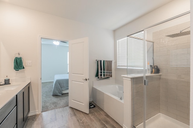 2825 Jasper Trl, Aubrey, TX 76227 - ensuite bathroom with a bath, a shower stall, wood finished floors, vanity, and ensuite bathroom