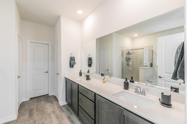 2825 Jasper Trl, Aubrey, TX 76227 - full bathroom featuring double vanity, a sink, wood finished floors, and a shower stall